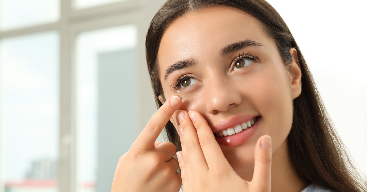 Woman inserting contact lens during Clear Lens Exchange in London, ON