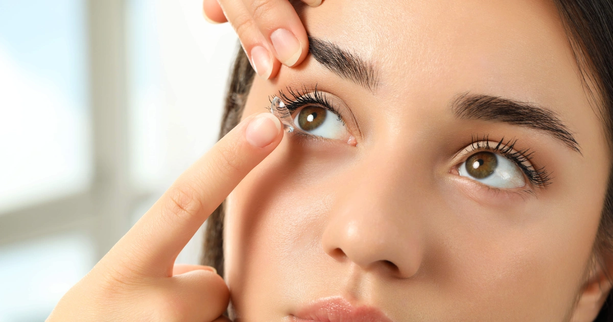Close-up of a woman receiving assistance while applying an Implantable Contact Lens in ON.